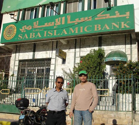 Saba Islamic Media Executive Director Bro Abu Bakar (left) stands with Cheb Ali in front of Saba Islamic Bank in Yemen. Though unrelated, the Saba brand name is familiar to Yemenis