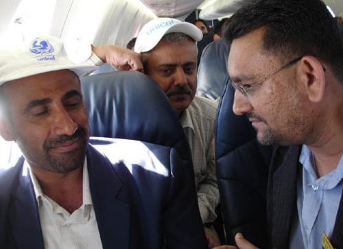 Conference coordinator Bro Shah Kirit (right) speaking with Yemeni officials aboard the chartered flight to Sayum